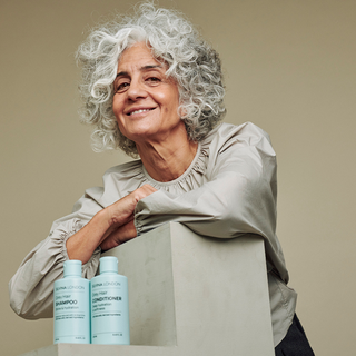Silvina Neder, founder of Silvina London, with shampoo and conditioner for grey hair