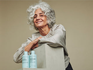 Silvina Neder, founder of Silvina London, with shampoo and conditioner for grey hair